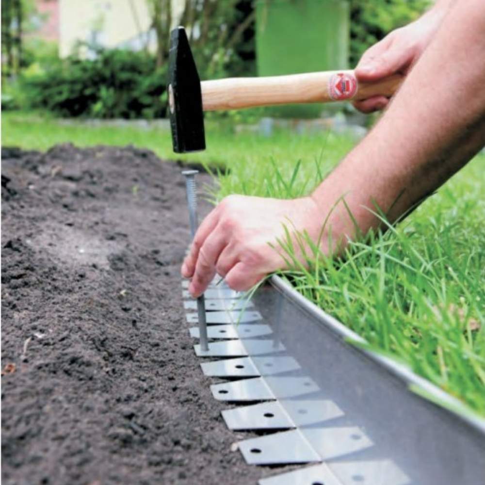 Stainless steel lawn edging with a bright finish along a lawn